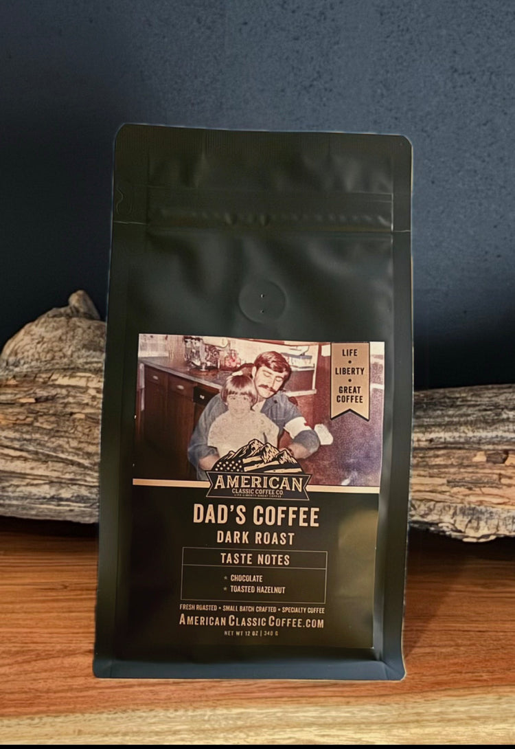 Bag of American Classic Dad's Coffee Dark Roast behind a log.